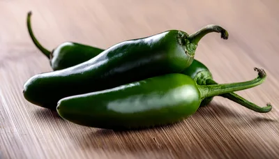 Fresh Green Jalapeno Peppers On Wooden Cutting Board