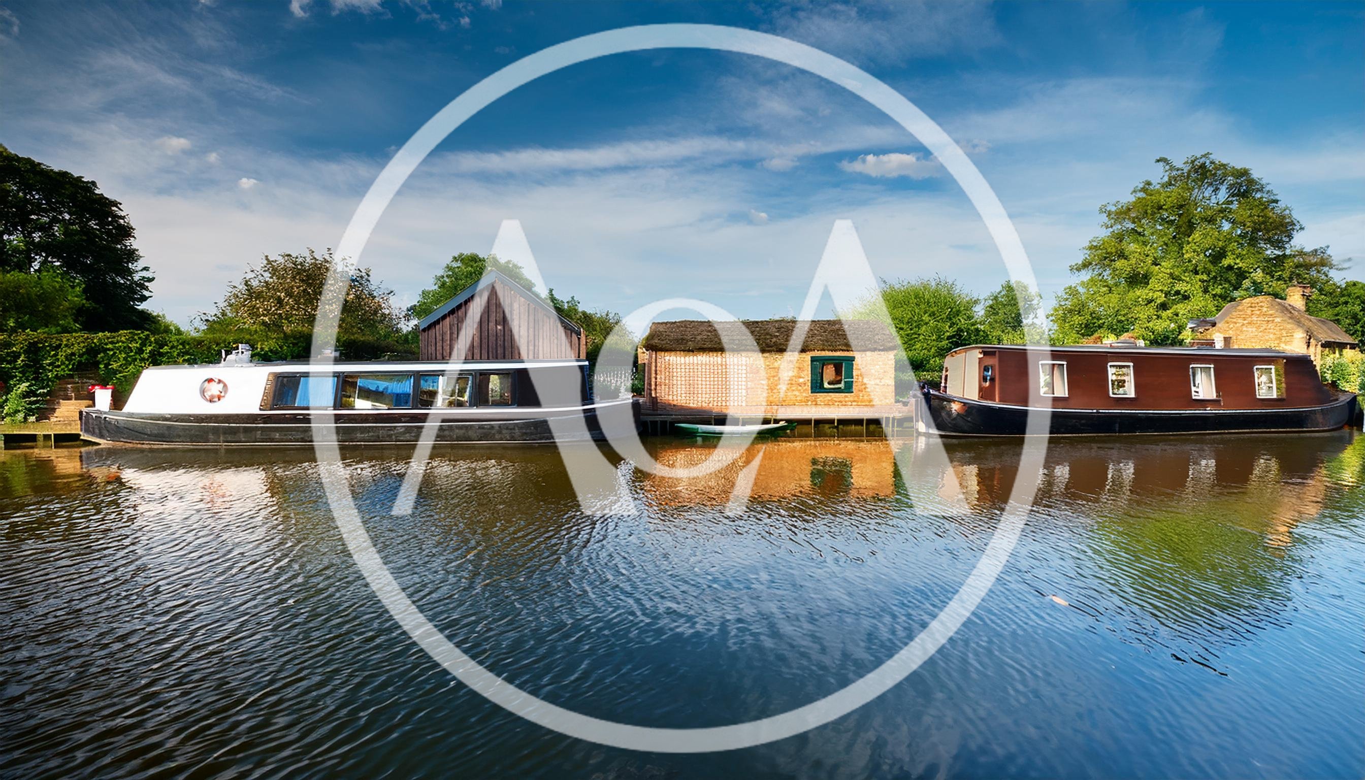 Narrowboats Moored Along A Peaceful Canal Bank