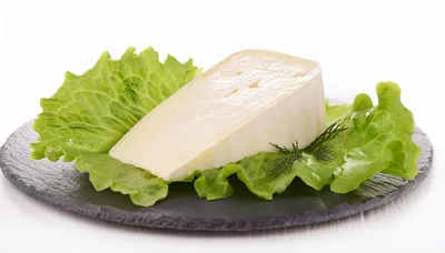 Wedge Of Creamy Cheese On A Slate Platter