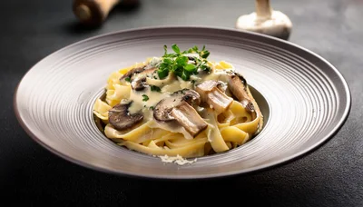 Creamy Mushroom Fettuccine Pasta In A Ceramic Bowl