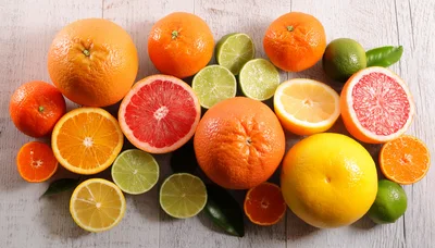 Assorted Fresh Citrus Fruits on Wooden Background