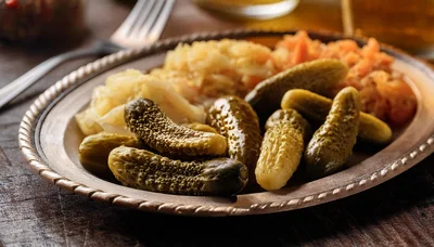 Pickles And Sauerkraut Served On A Metal Plate