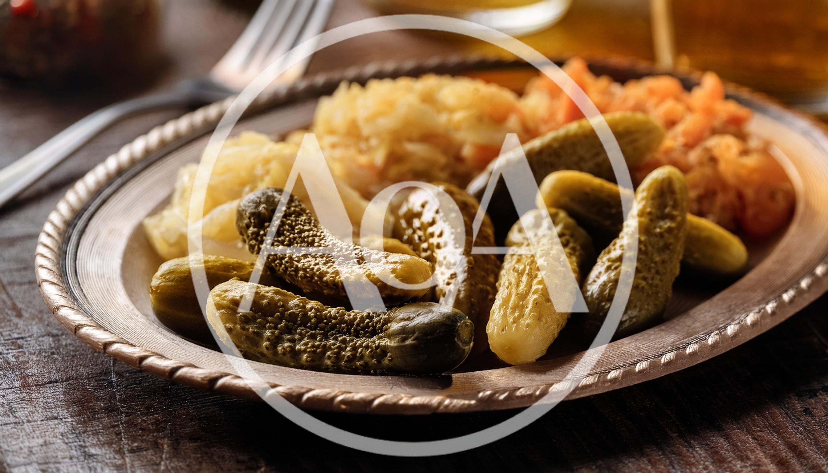 Pickles And Sauerkraut Served On A Metal Plate