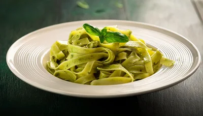 Plate Of Fresh Fettuccine Pasta With Pesto Sauce