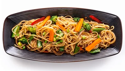 Stir Fried Vegetable Noodles On A Black Plate