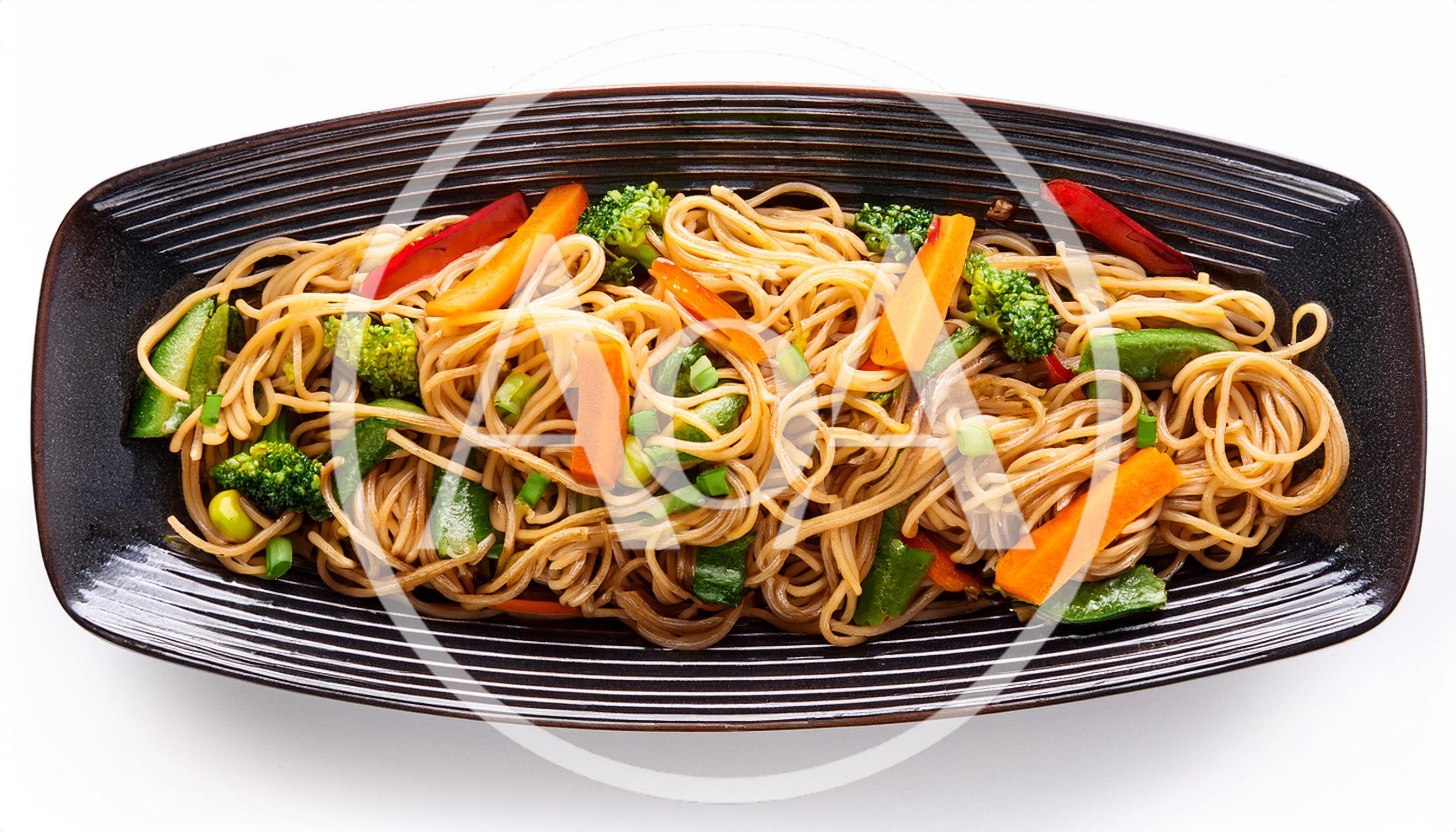 Stir Fried Vegetable Noodles On A Black Plate