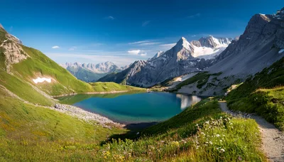 Alpine Lake Surrounded By Snow Capped Mountains