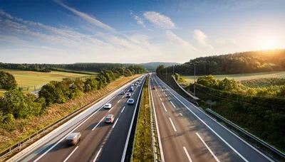 Cars Driving on a Highway at Sunset