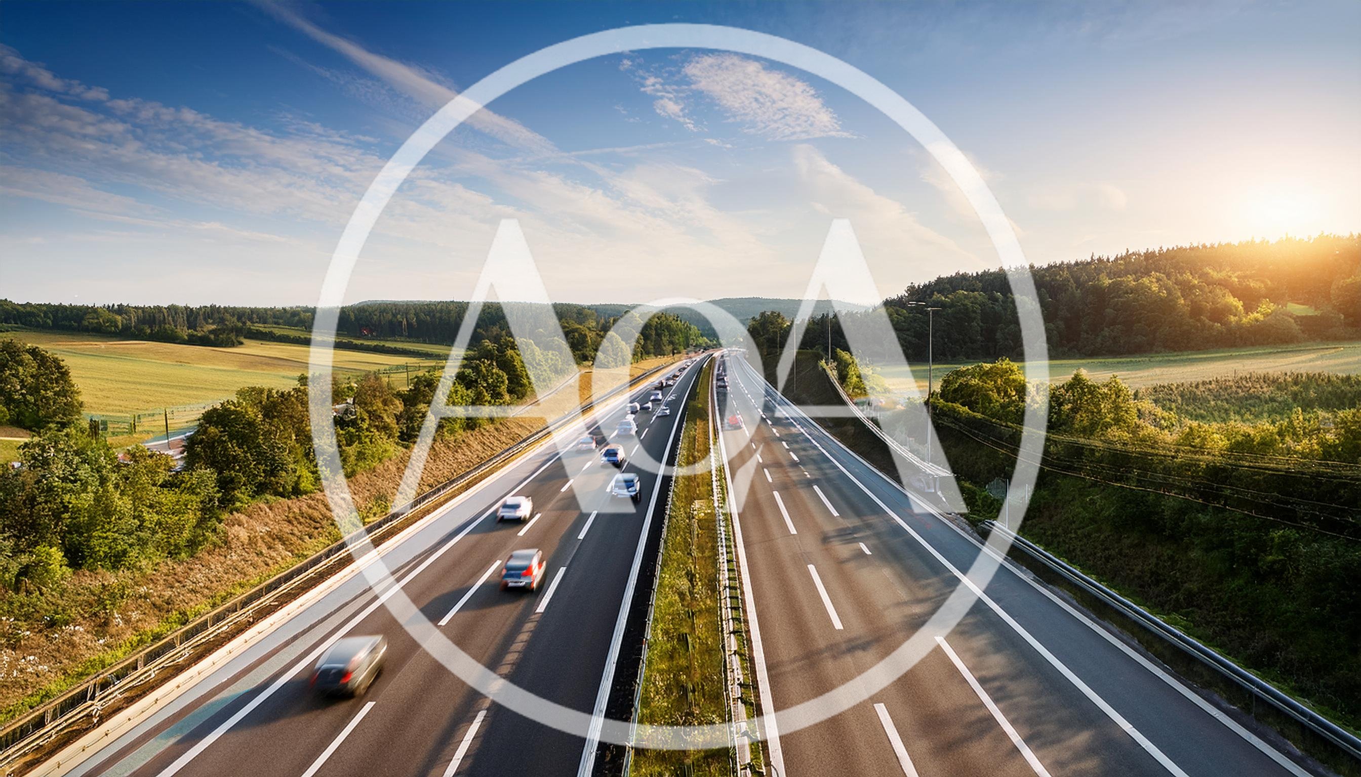 Cars Driving on a Highway at Sunset