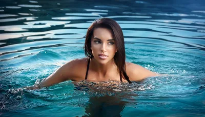 Beautiful Woman Swimming In A Clear Blue Pool