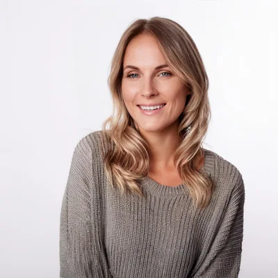 Portrait Of A Smiling Blonde Woman In A Sweater