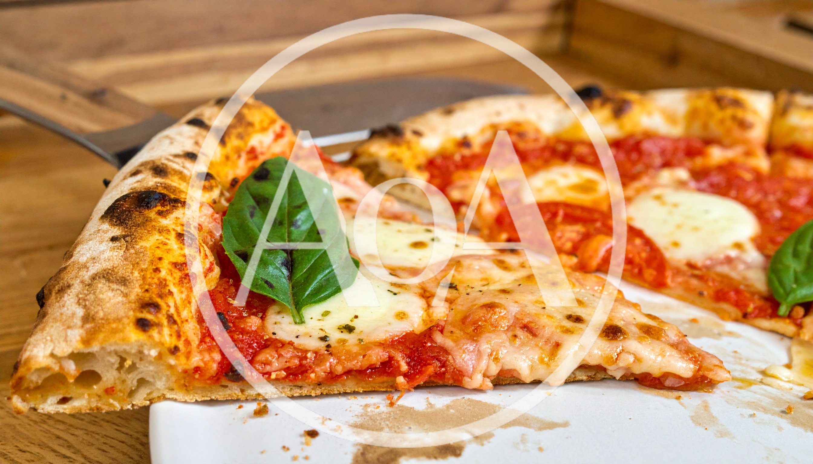 Freshly Baked Margherita Pizza Slice on Wooden Table