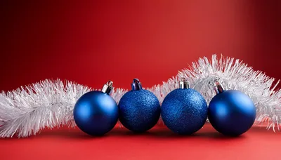Four Blue Christmas Ornaments With Silver Tinsel
