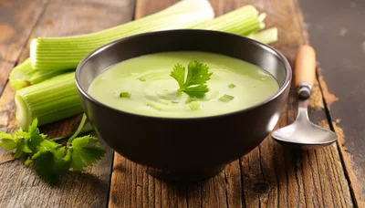 Bowl Of Creamy Celery Soup On Rustic Wooden Table