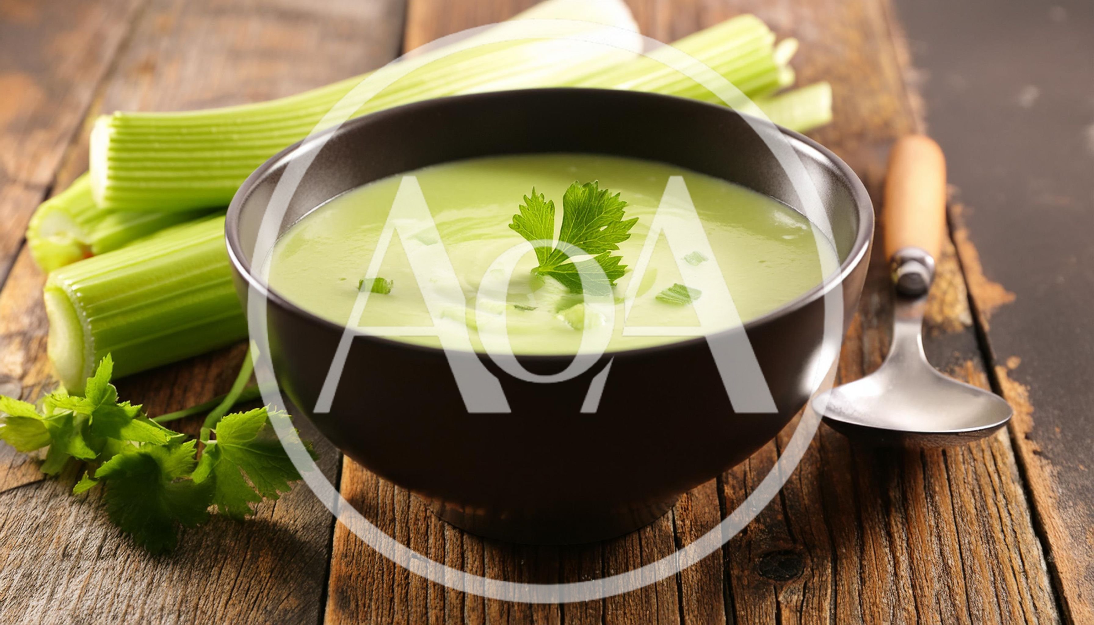 Bowl Of Creamy Celery Soup On Rustic Wooden Table