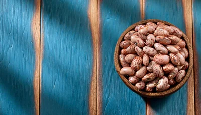 Pinto Beans In A Wooden Bowl On Blue Wood