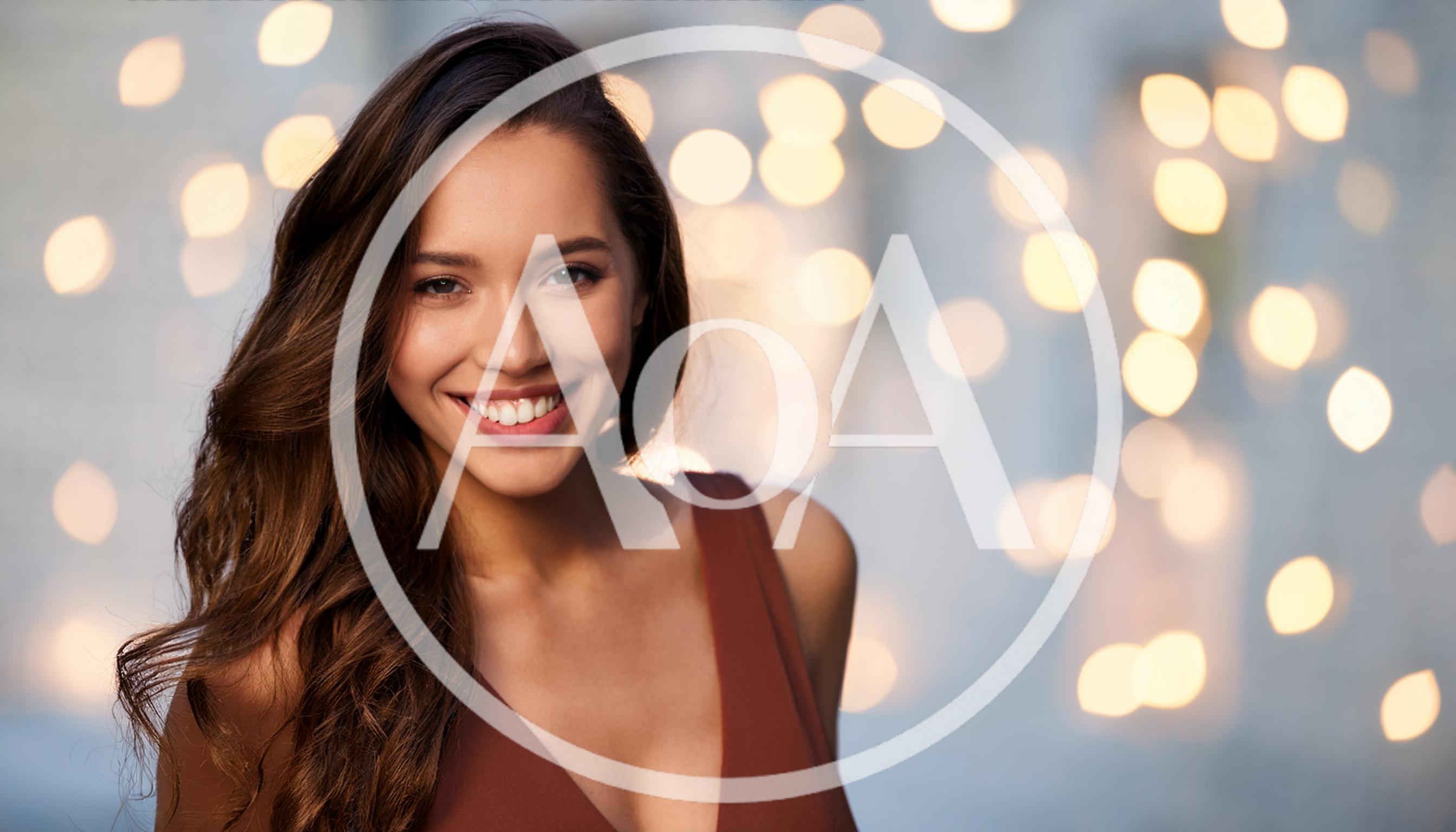 Portrait Of A Smiling Young Woman With Long Hair