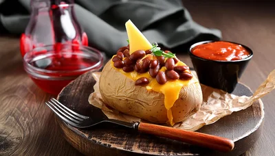 Baked Potato Topped With Beans And Melted Cheese