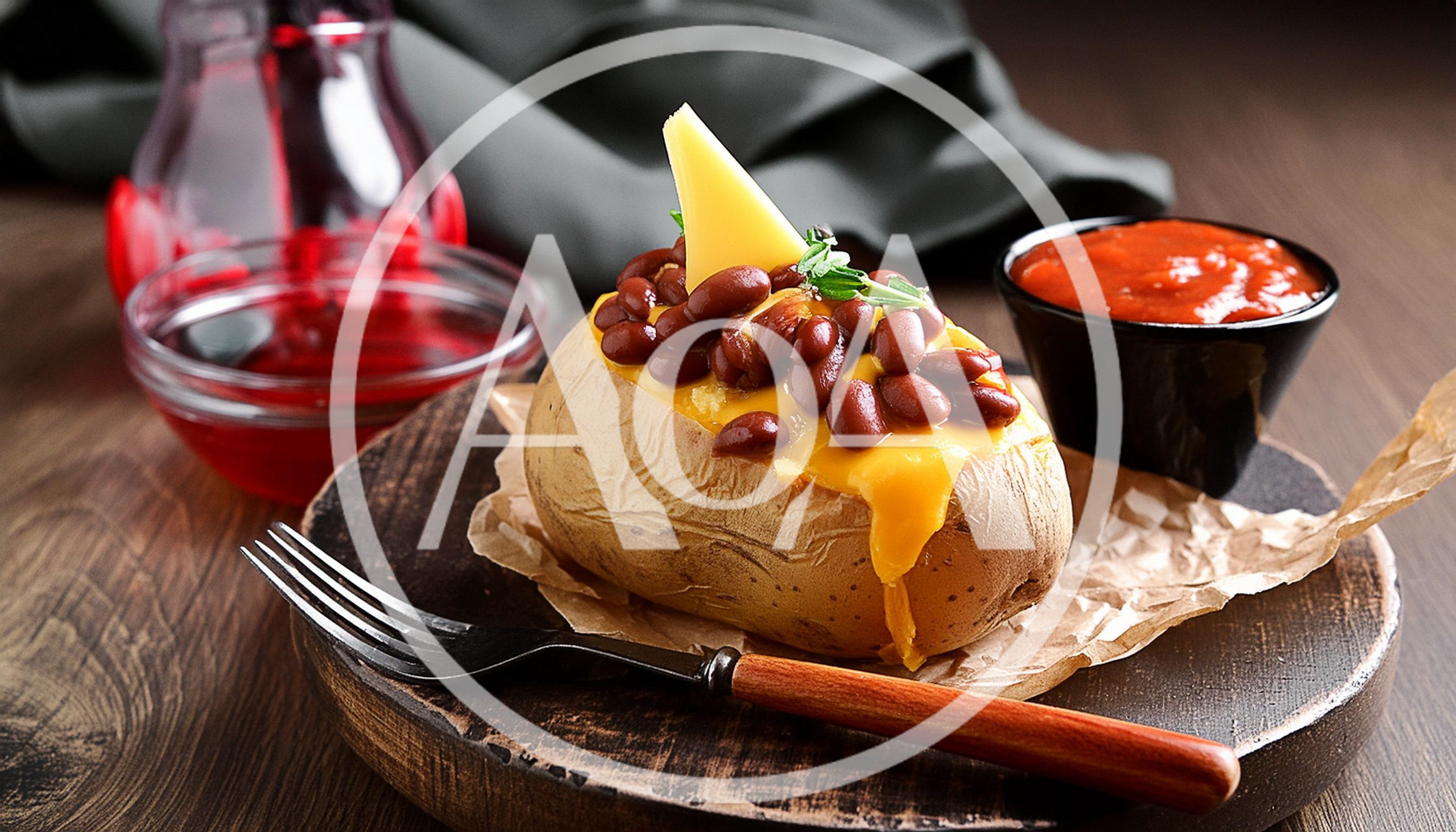Baked Potato Topped With Beans And Melted Cheese