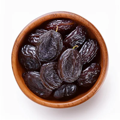 Dried Prunes In A Wooden Bowl