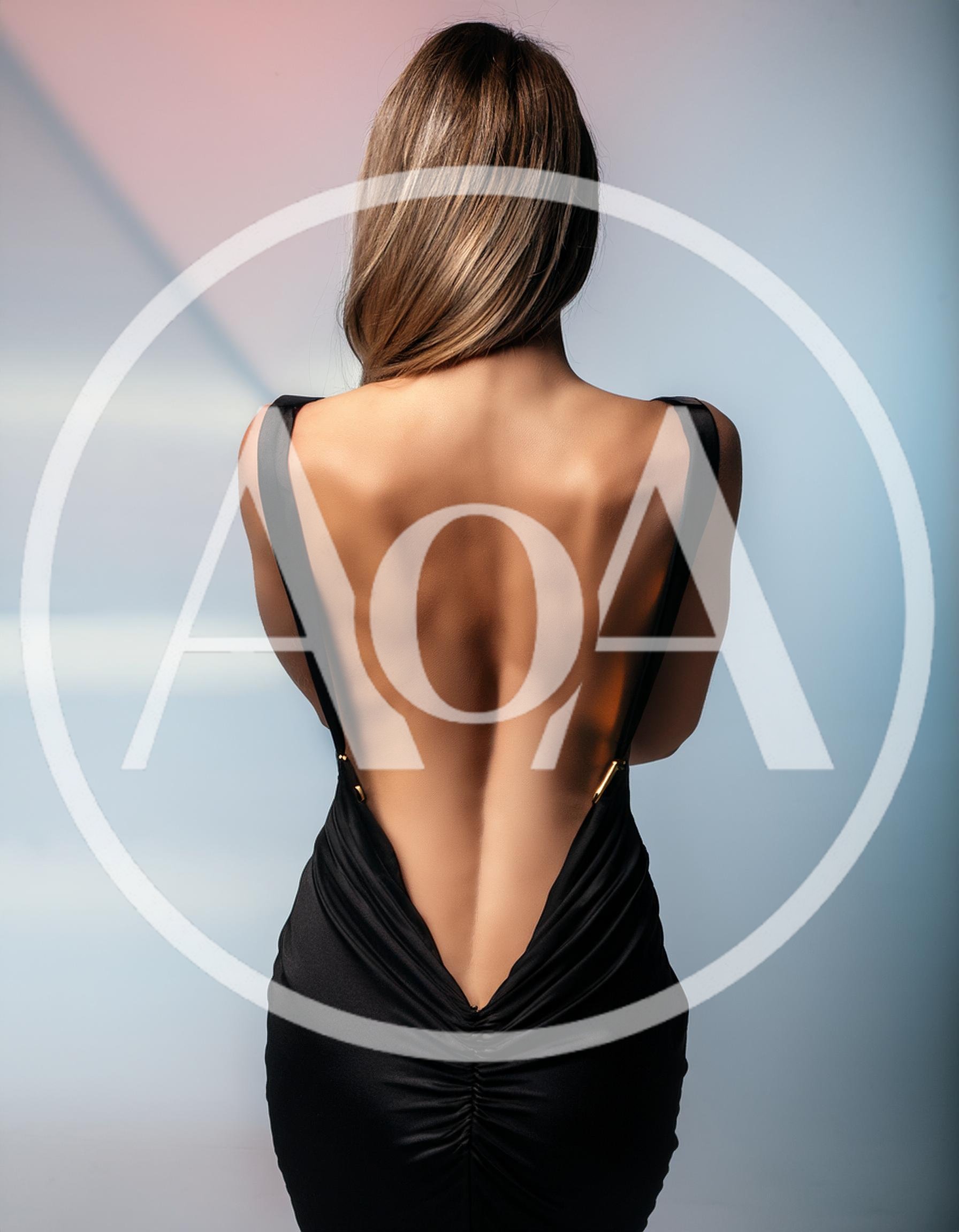 Woman In Elegant Black Backless Evening Dress