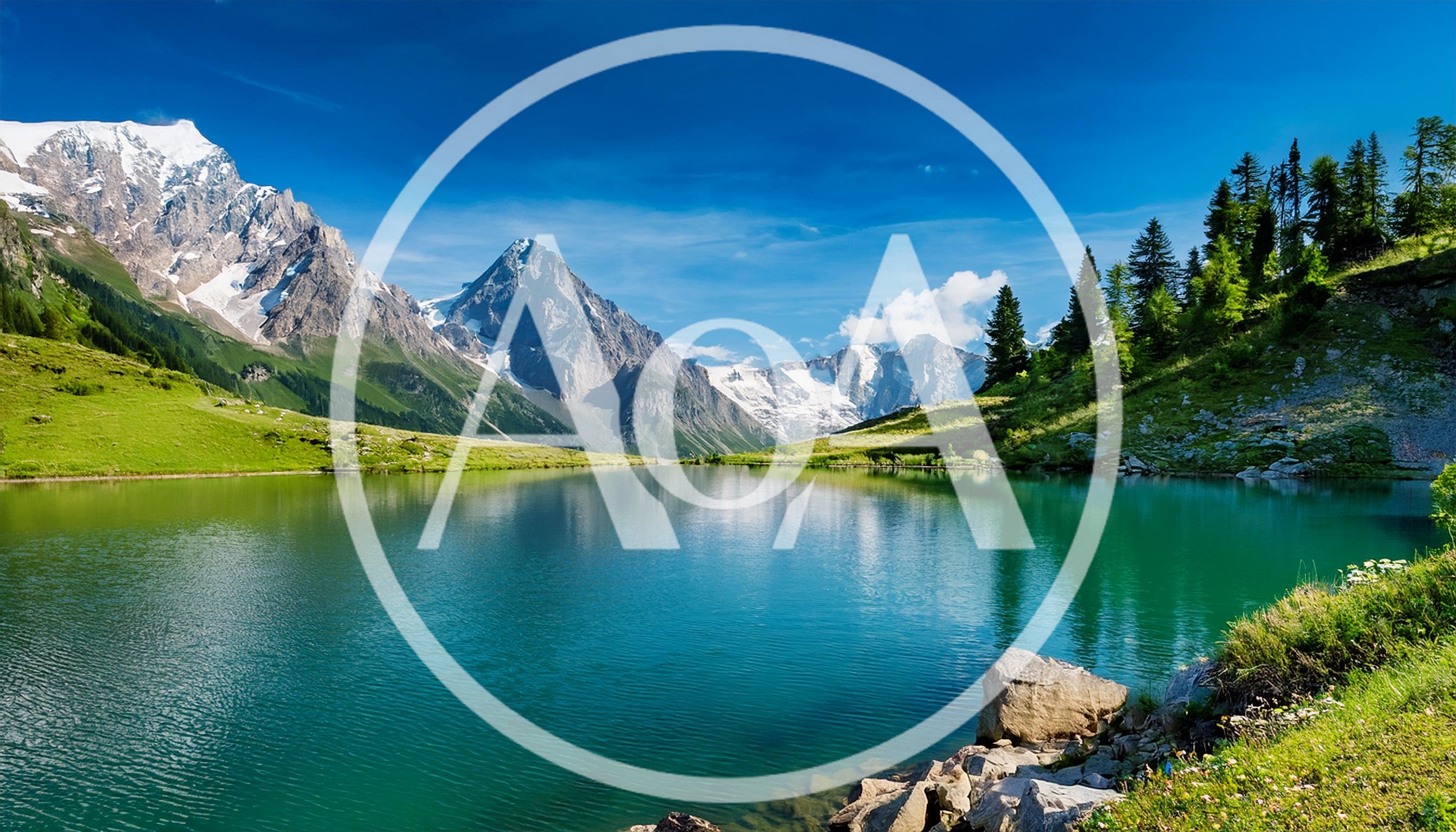 Stunning Alpine Lake With Snow Capped Mountain Peaks