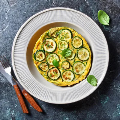 Zucchini Frittata Served On A Plate With Cutlery