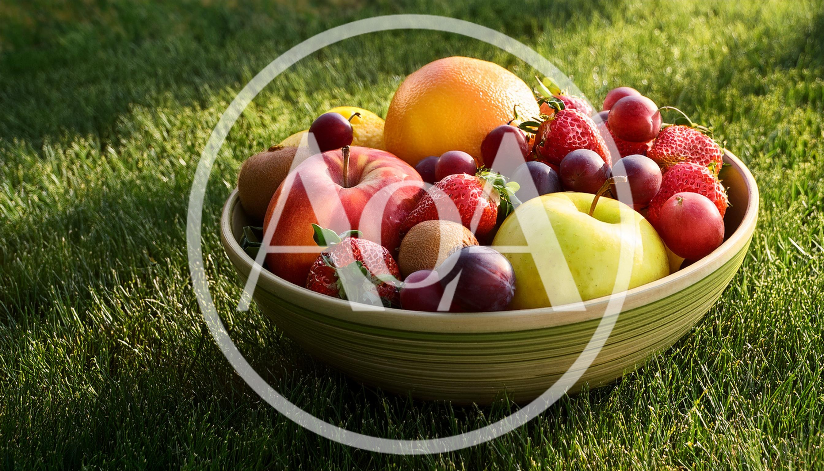 Fresh Assorted Fruit Bowl on Green Grass