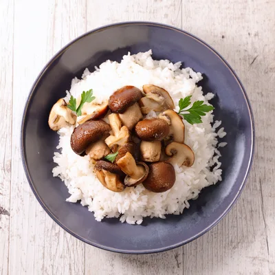 Bowl Of Steamed White Rice With Sautéed Mushrooms