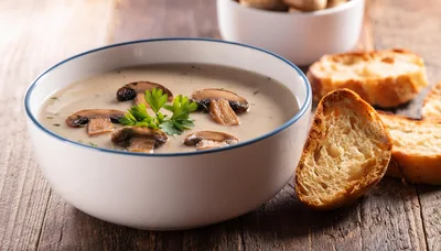 Creamy Mushroom Soup Served In A White Bowl