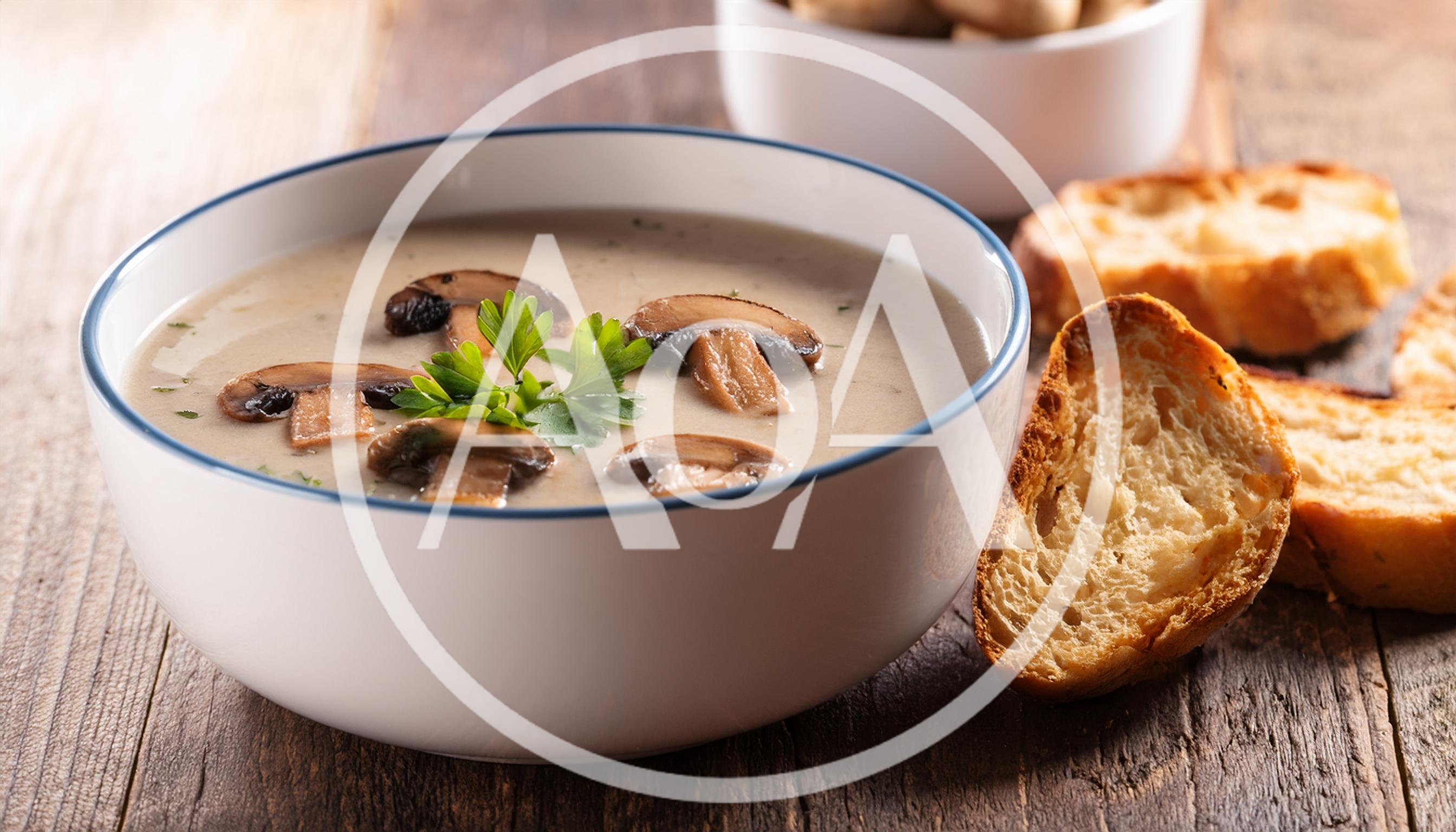 Creamy Mushroom Soup Served In A White Bowl