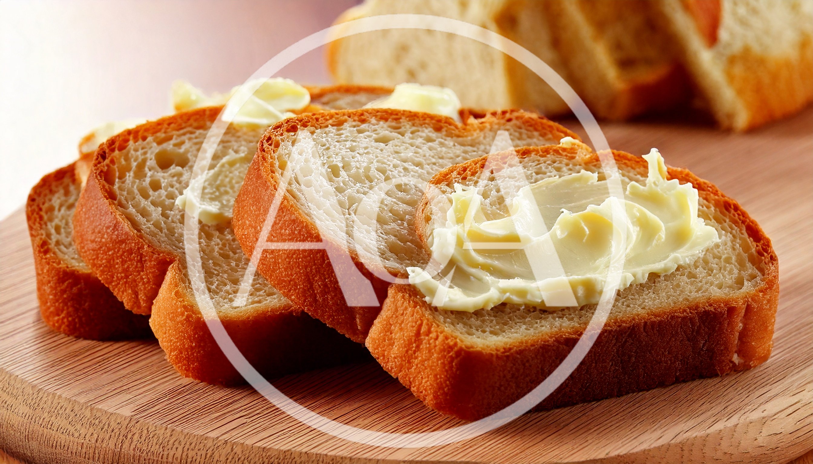 Slices Of Fresh Bread With Butter On Wooden Board
