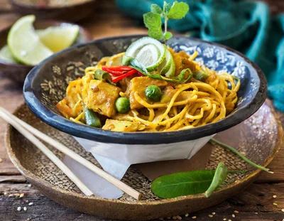Bowl Of Yellow Curry Noodles With Tofu And Vegetables