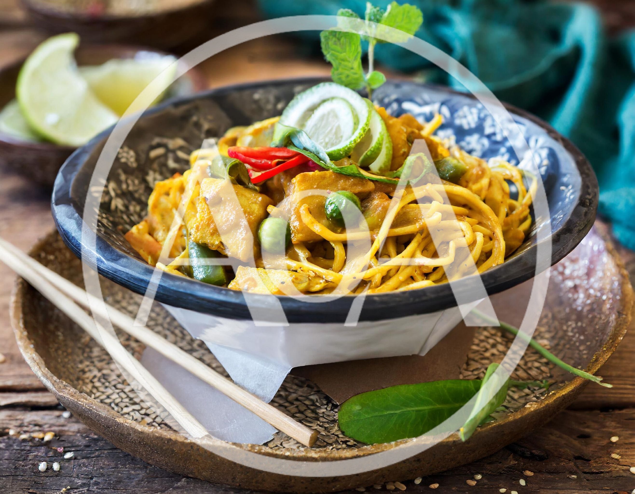 Bowl Of Yellow Curry Noodles With Tofu And Vegetables