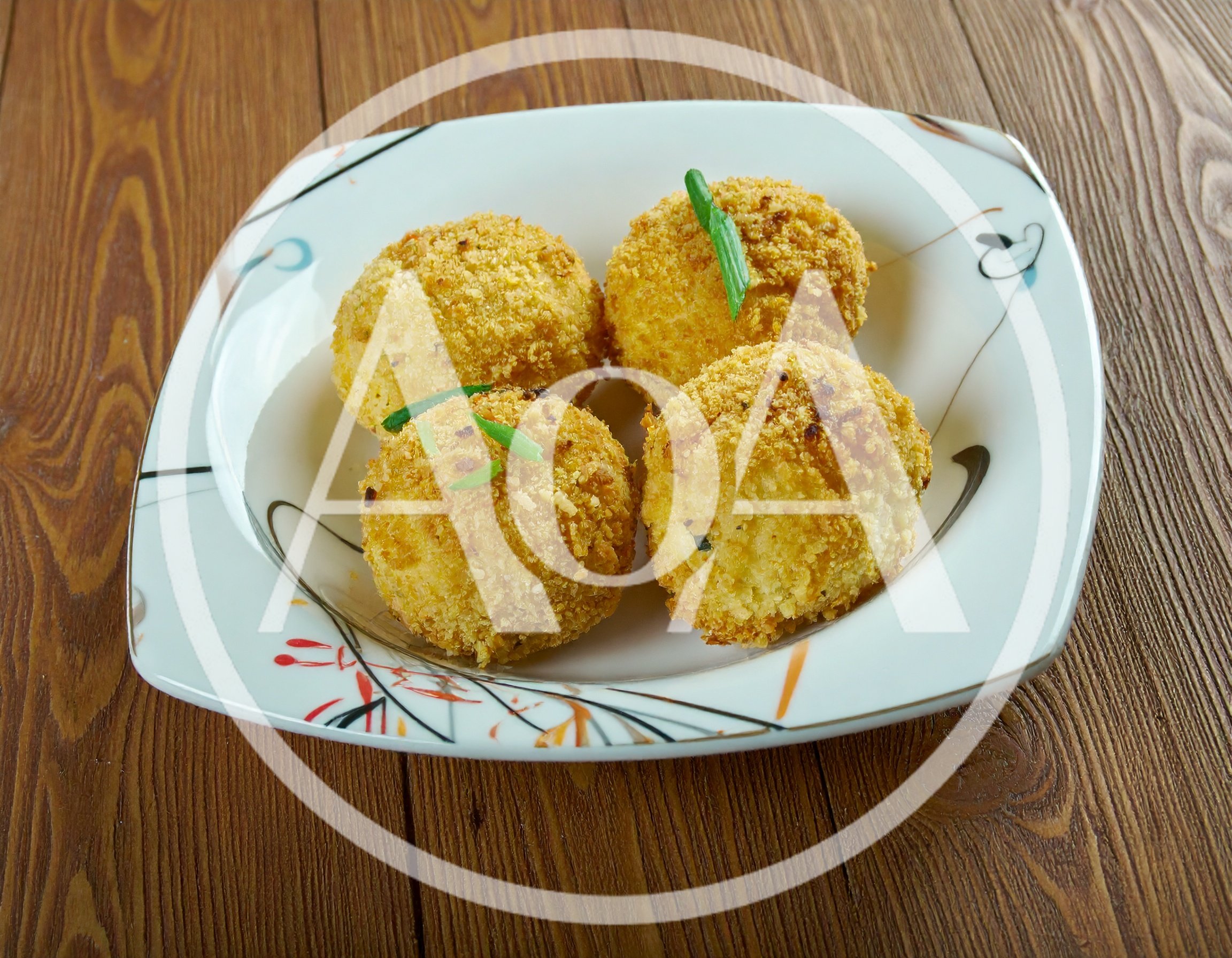 Four Golden Fried Potato Croquettes On A Plate