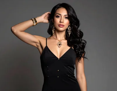 Elegant Woman Posing In Black Dress And Jewelry