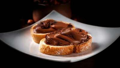 Two Slices Of Bread With Chocolate Hazelnut Spread