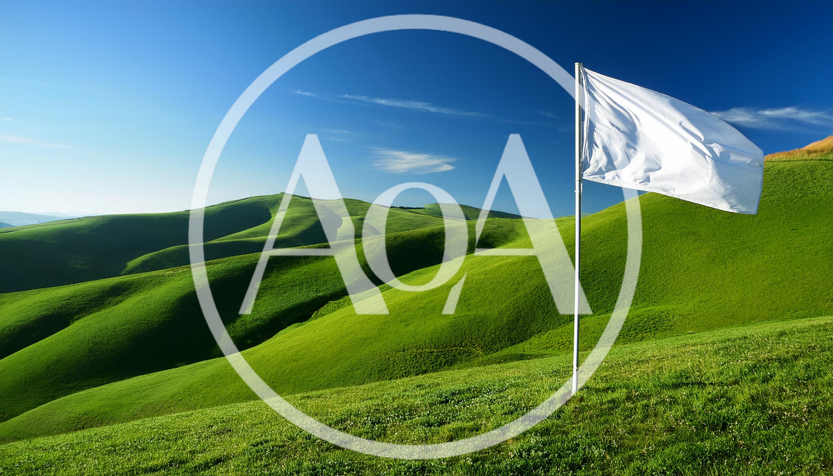White Flag Waving On A Green Hillside