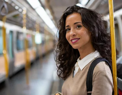 Young Woman Commuting On A Subway Train