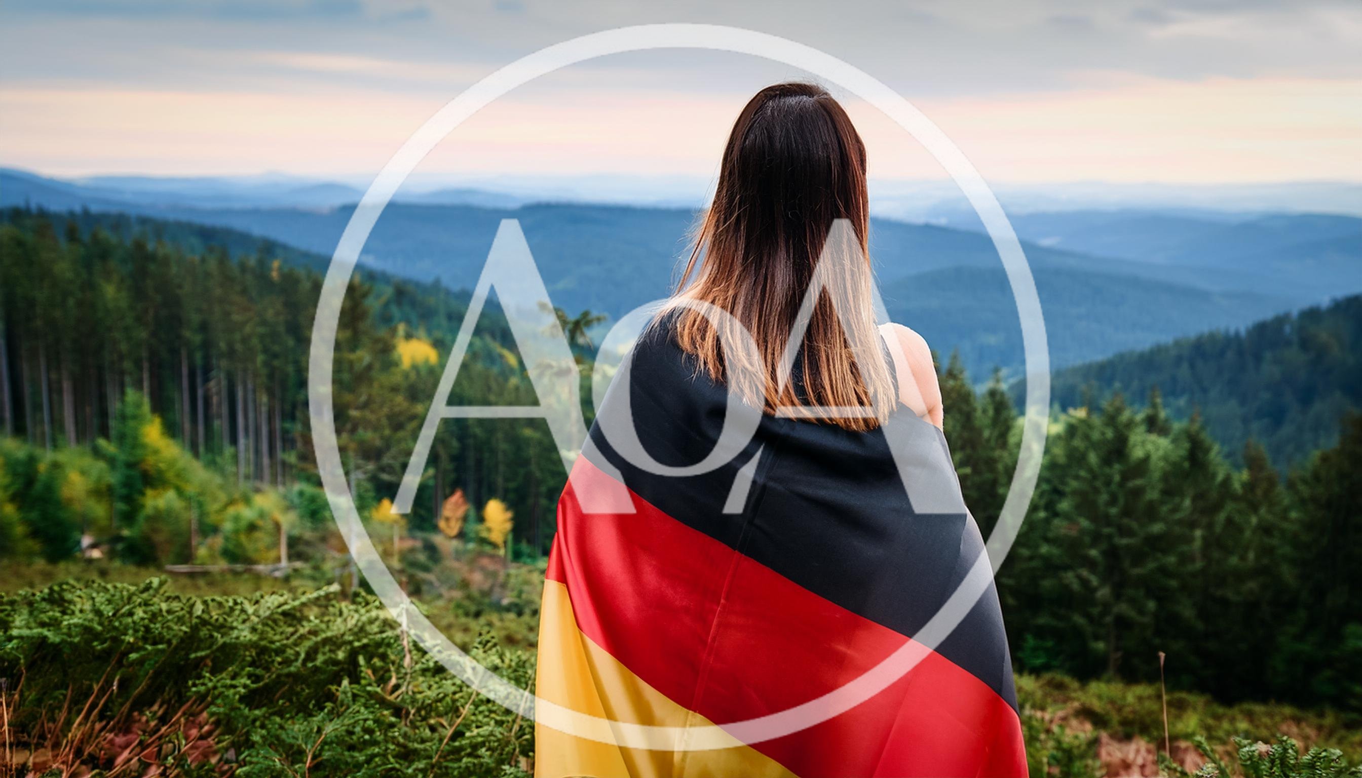 Woman Wrapped In German Flag Overlooking Mountain Landscape