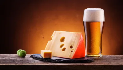 Wedge of Swiss Cheese and Glass of Beer