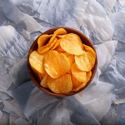 Wooden Bowl Filled With Crispy Potato Chips