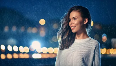Smiling Young Woman Standing Outside During Night Rain