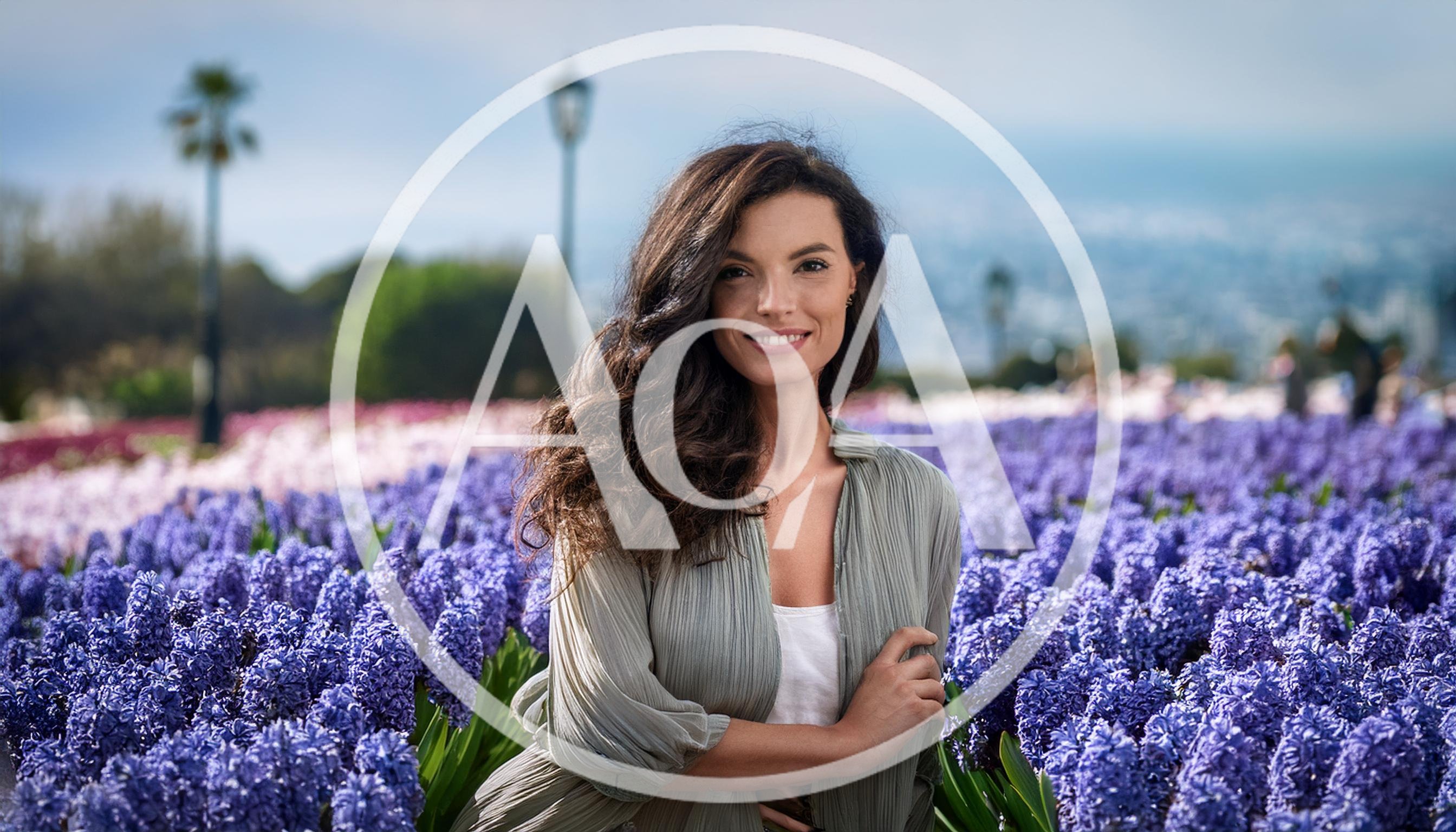Beautiful Woman Posing In A Field Of Purple Hyacinths