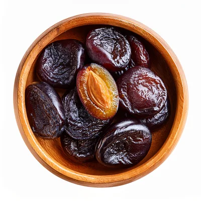Dried Plums In A Wooden Bowl