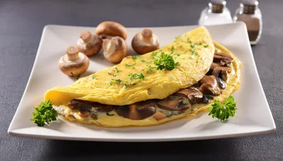 Mushroom Omelet Served On A White Plate