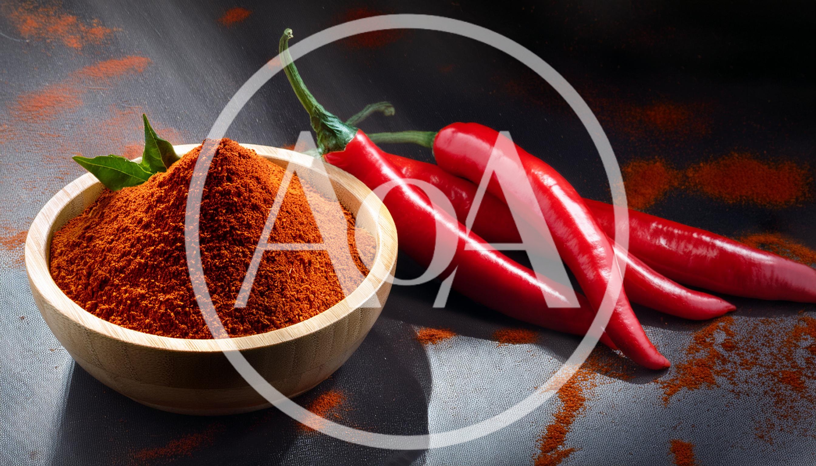 Wooden Bowl Of Chili Powder With Fresh Red Peppers