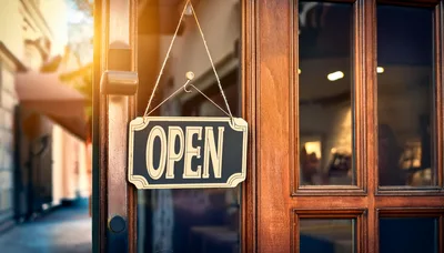 Open Sign Hanging On A Wooden Storefront Door