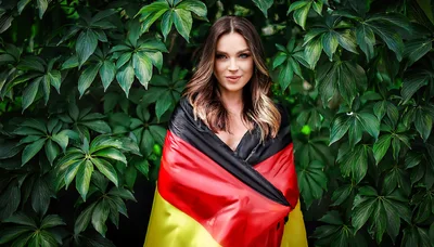 Young Woman Wrapped In A German Flag