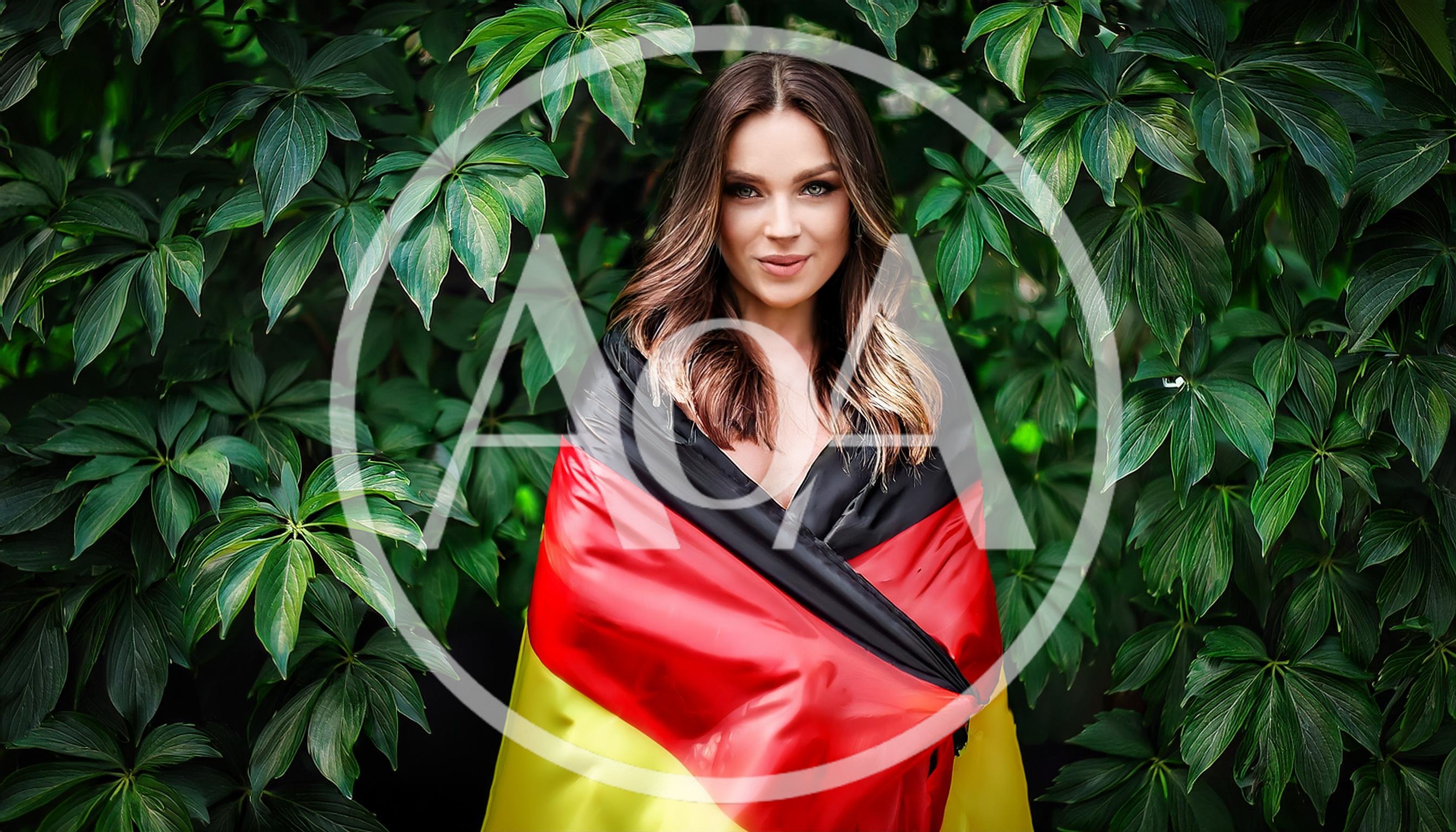 Young Woman Wrapped In A German Flag